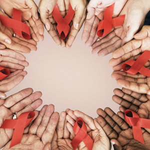 open hands in a circle; each holds a red ribbon