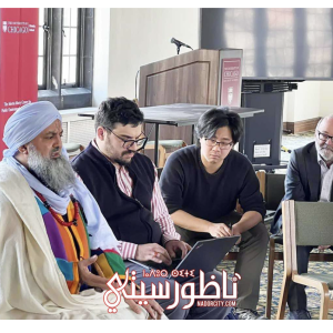 Sheikh Muhammad Fawzi Al-Karkari speaks to two students and Dean Jim Robinson in the Swift Hall lecture Hall