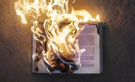 Book in flames against dark background