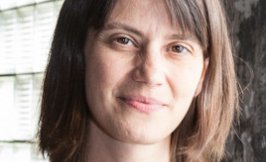 Headshot of a woman with shoulder length brown hair and bangs