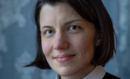 Headshot of a woman with short brown hair wearing clerical garments.