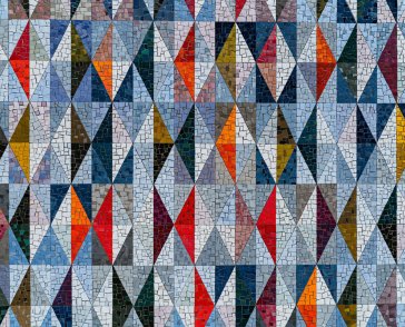 Abstract geometric mosaic made up of varying shades of red, blue, and yellow triangles.