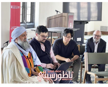 Sheikh Muhammad Fawzi Al-Karkari speaks to two students and Dean Jim robinson in Swift Hall