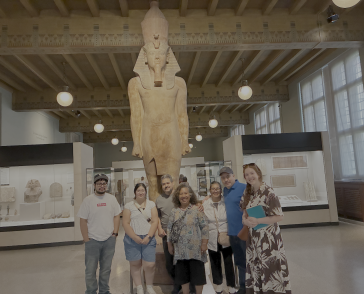 Group of people at a museum in front of a statue