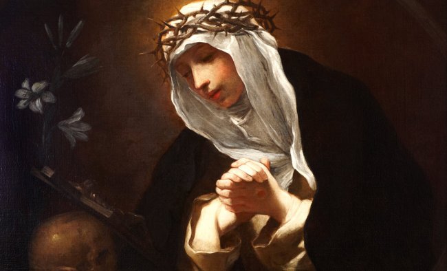 Saint Catherine of Siena in white veil and crown of thorns, looking down.