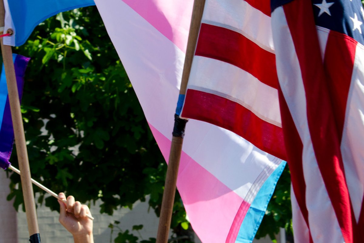 Rainbow Pride flag, transgender flag, and American flag