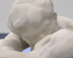 Two white marble figures embrace