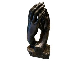 Two intertwined dark bronze hands lightly touching at the fingertips with small space in between