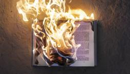 Book in flames against dark background